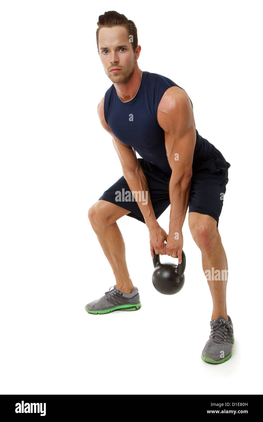 Young attractive male doing kettle bell cross fit exercise Stock Photo