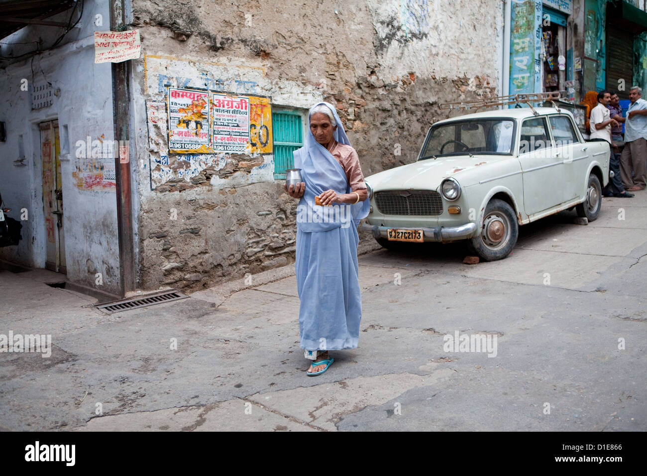 Woman in colourful sari walking hi-res stock photography and images - Alamy