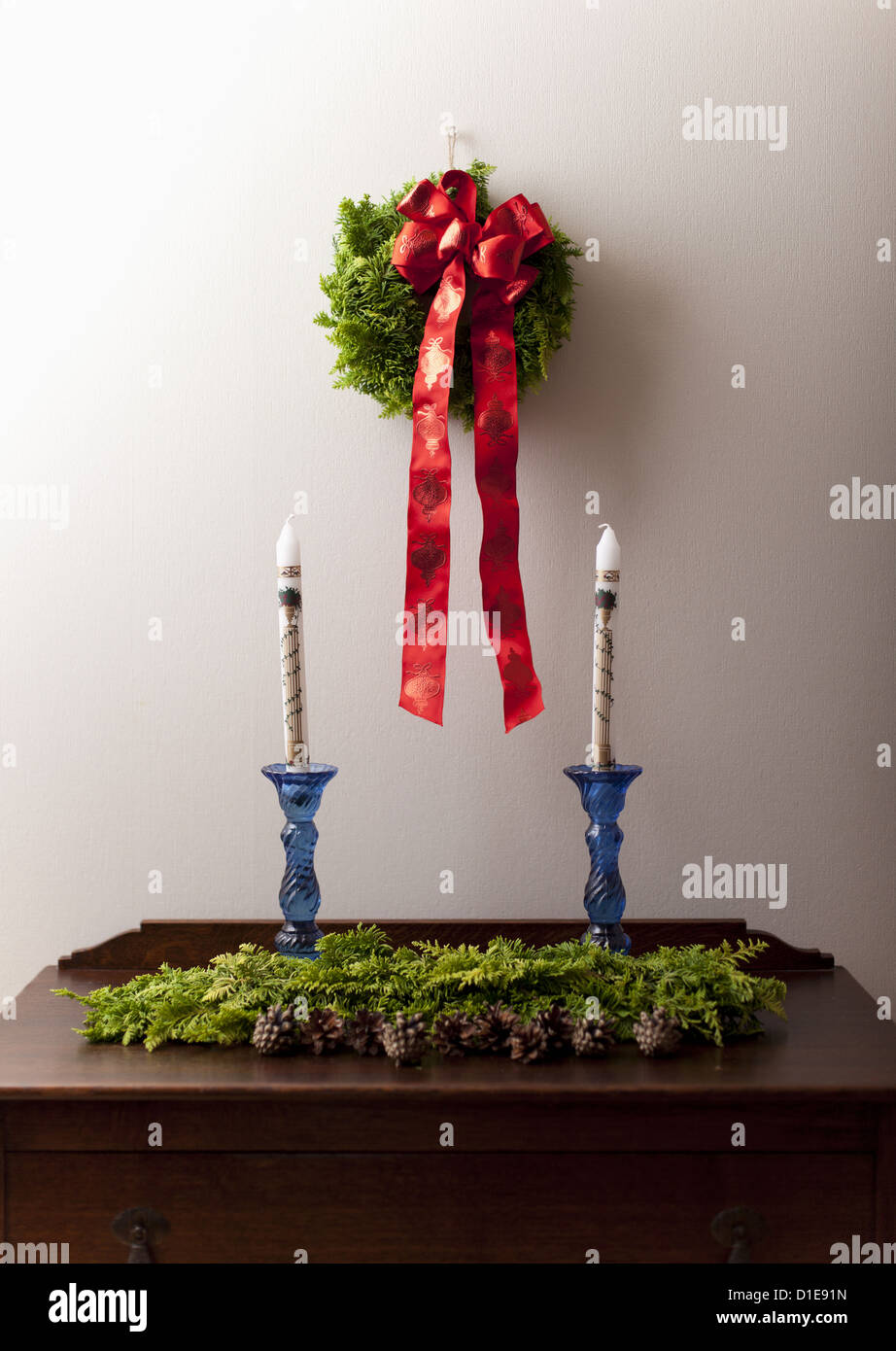 Wreath on a wall and candles Stock Photo