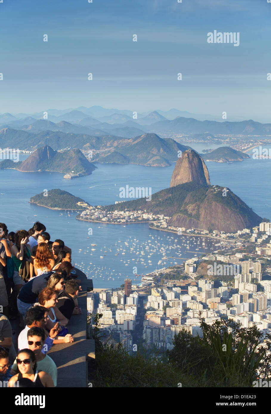 Tourists enjoying view of Sugar Loaf Mountain (Pao de Acucar) and Botafogo Bay from Corvocado, Rio de Janeiro, Brazil Stock Photo