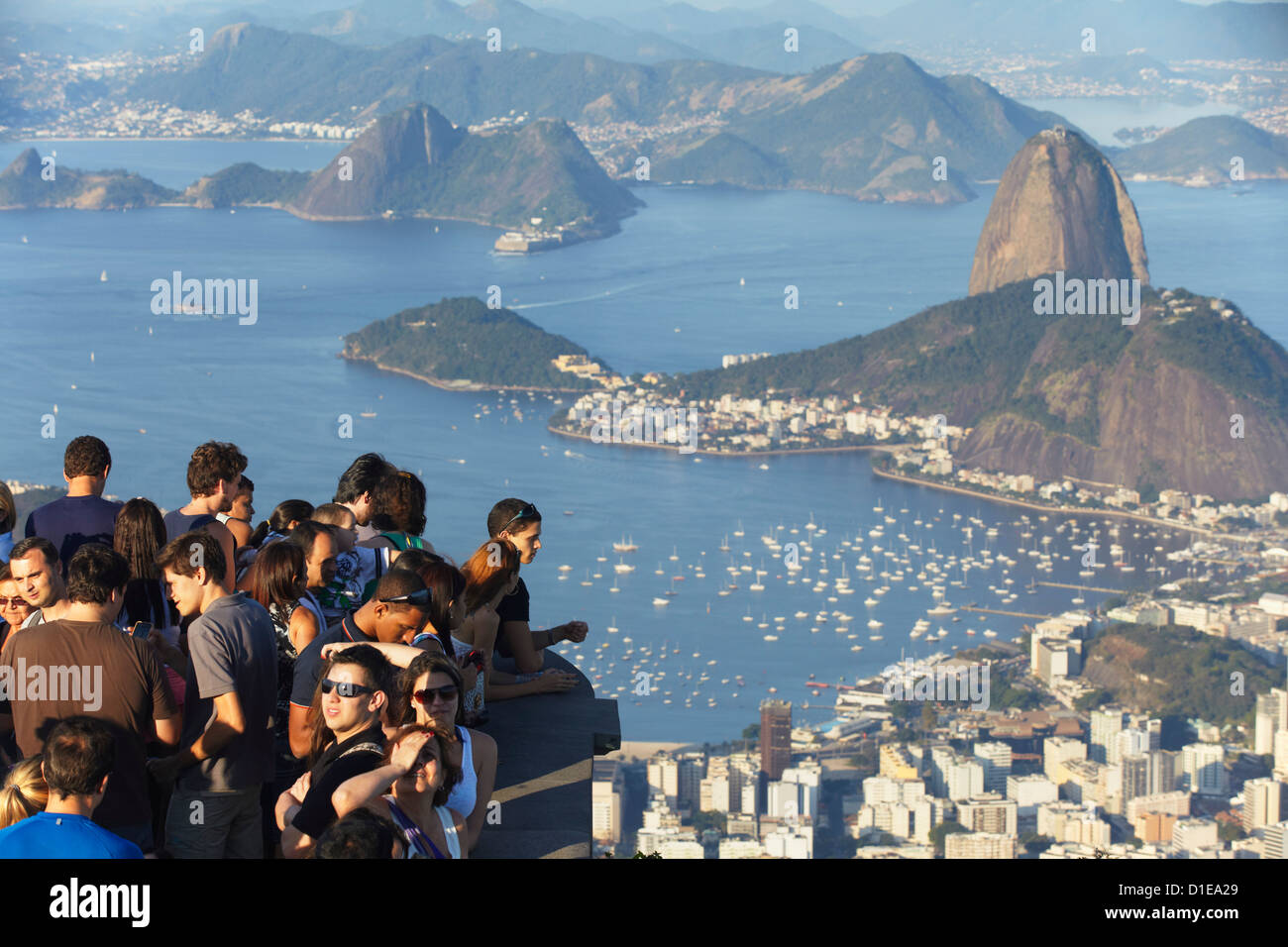 Tourists enjoying view of Sugar Loaf Mountain (Pao de Acucar) and Botafogo Bay from Corvocado, Rio de Janeiro, Brazil Stock Photo