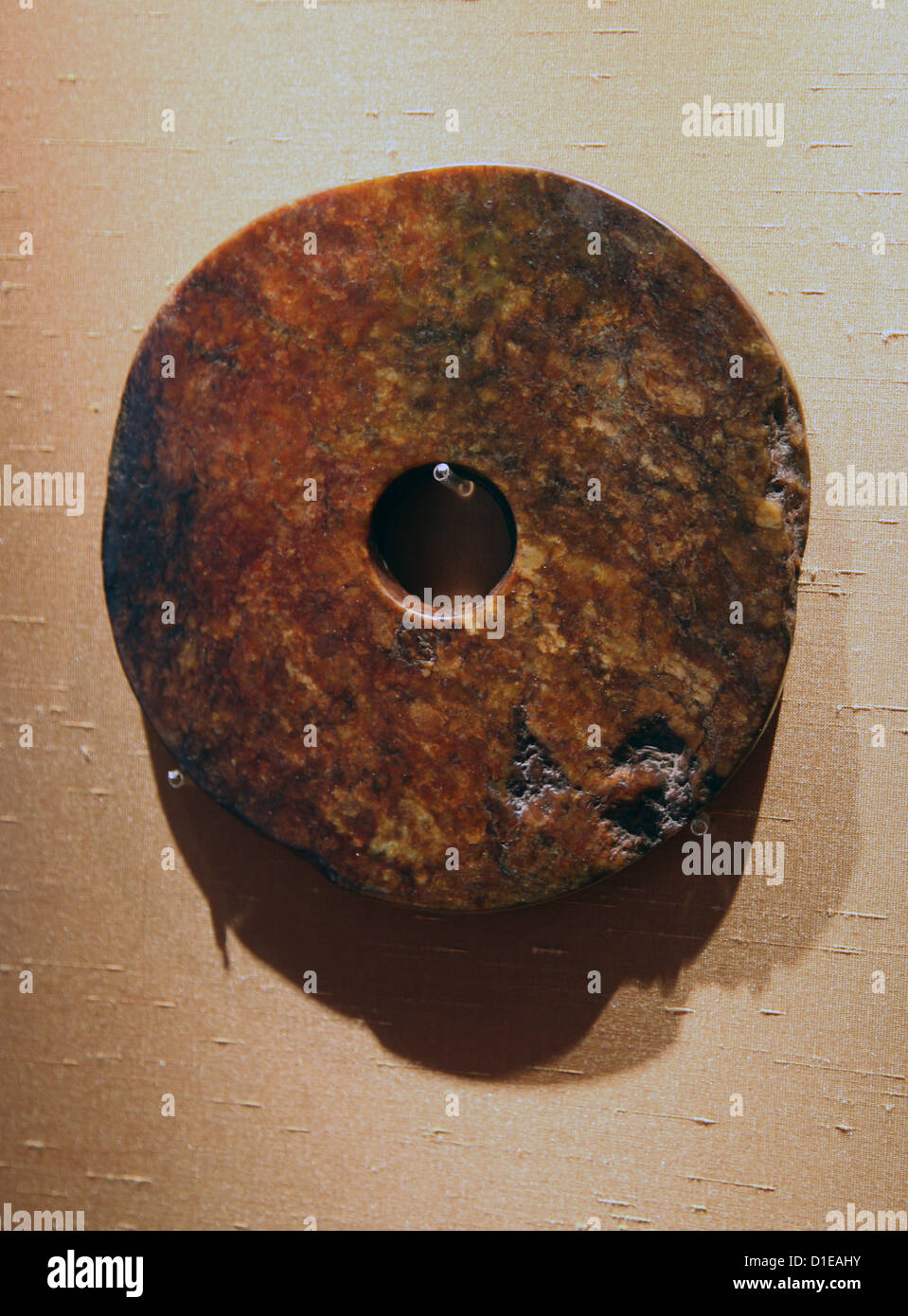 It's a photo of an ancient Chinese jade disc called bi. It was use as a symbol of rank. A bi is a flat jade disc with a circular Stock Photo
