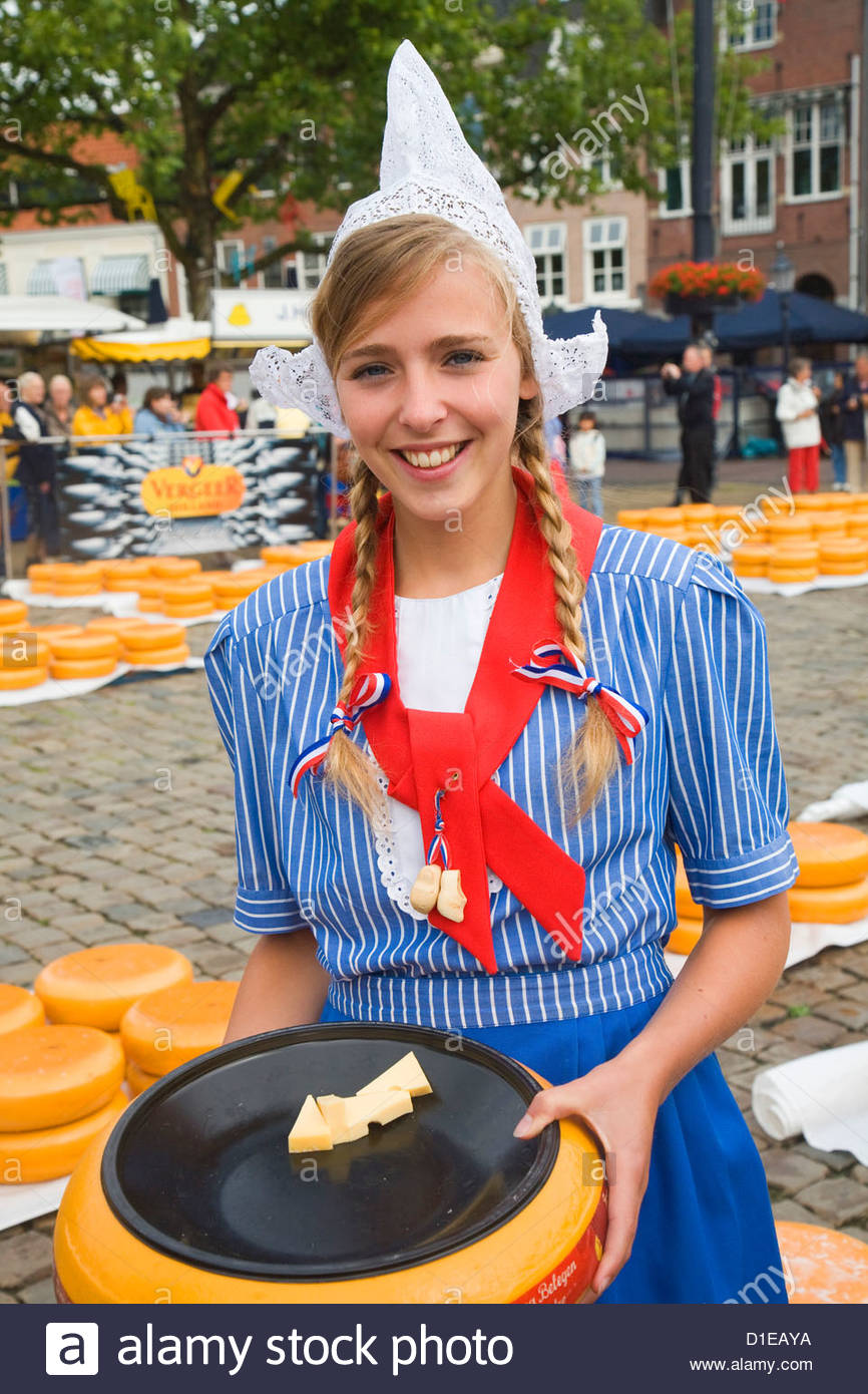 Pretty young woman in Dutch national costume at Gouda cheese market