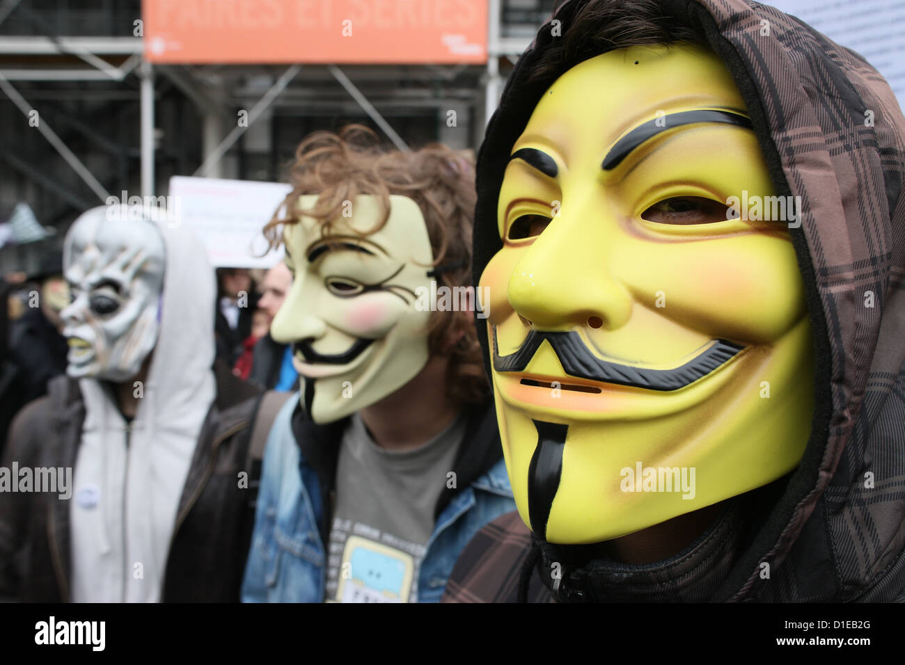 Protestors wearing Guy Fawkes masks of the Anonymous movement, based on a character in the film V for Vendetta, Paris, France Stock Photo