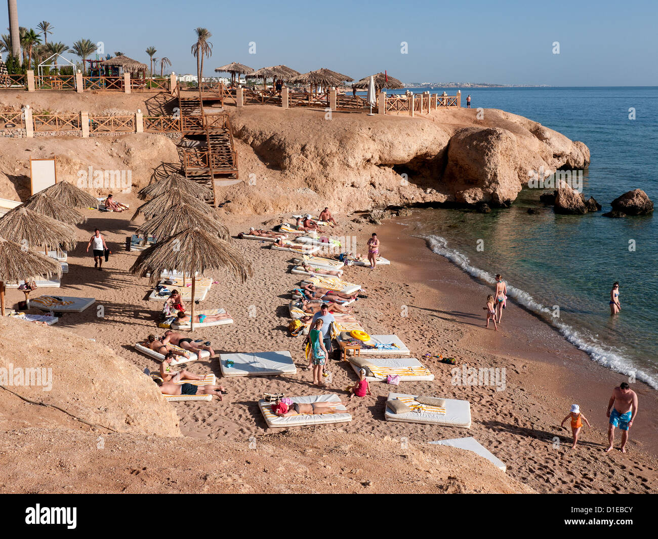 A private beach with sunbathing mattresses at the Hilton Sharm Waterfall Resort, Sharm El Sheikh, Egypt Stock Photo