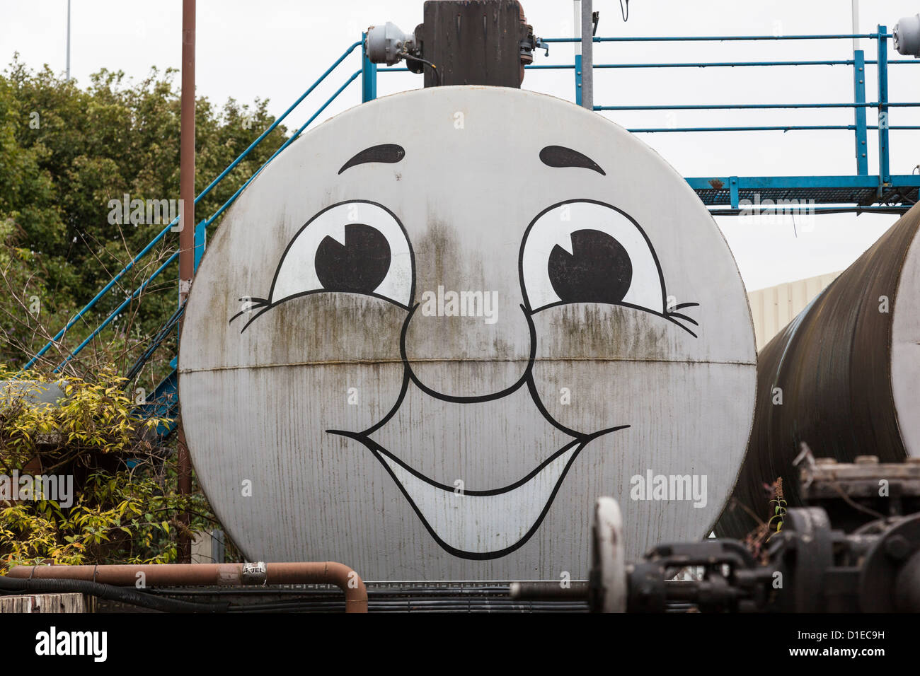Storage tank with amusing 'Thomas the Tank Engine' face painted on it. Stock Photo