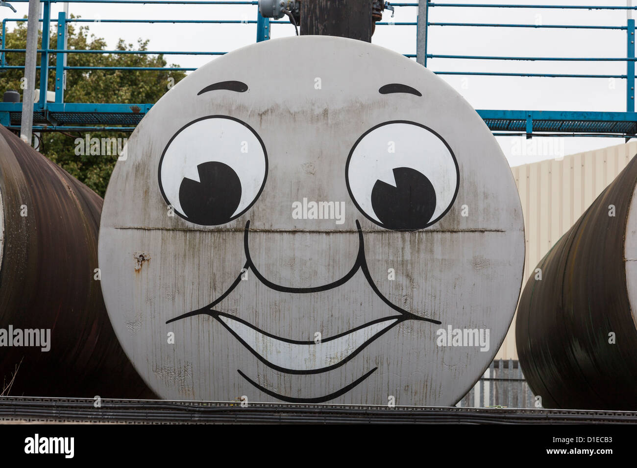 Storage tank with amusing 'Thomas the Tank Engine' face painted on it. Stock Photo