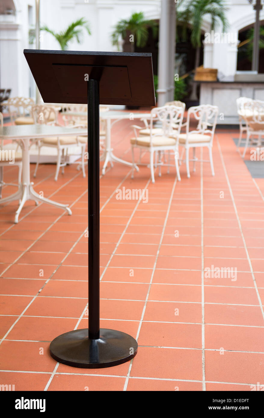 Standing menu board with outdoor cafe and bar on background Stock Photo