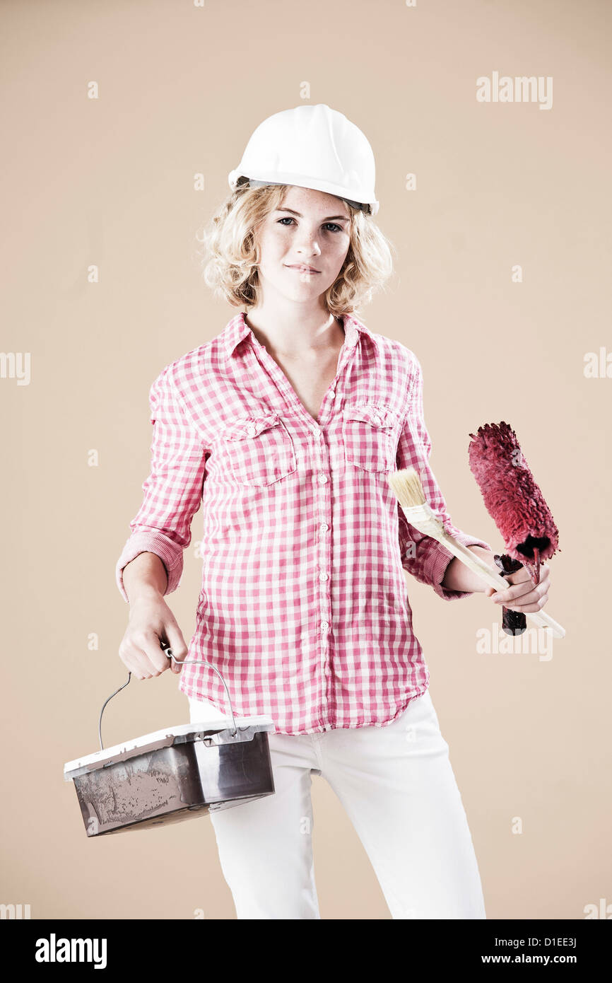 Teenage girl with hard helm and paint bucket Stock Photo