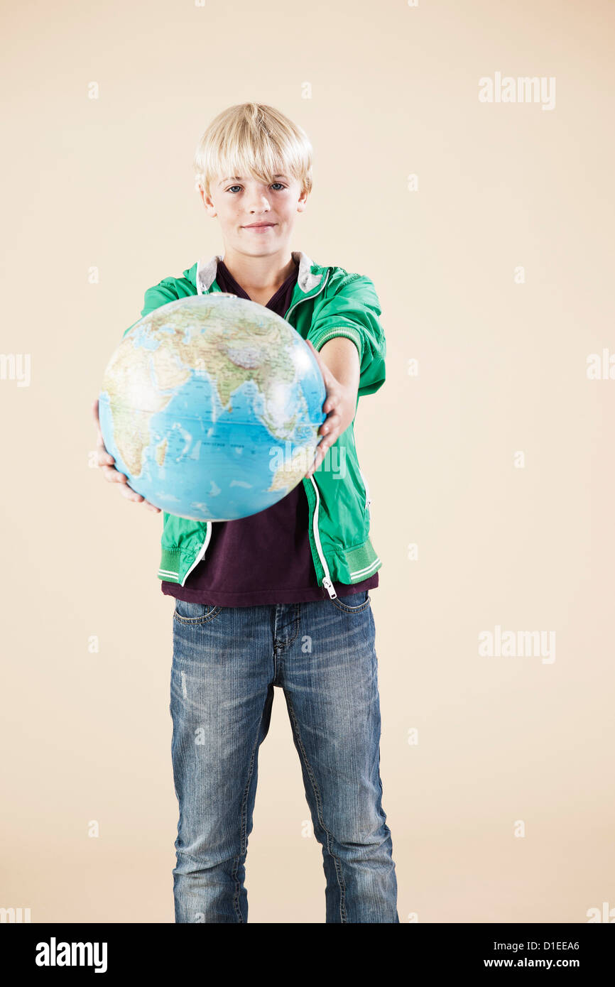 Blond boy with globe Stock Photo