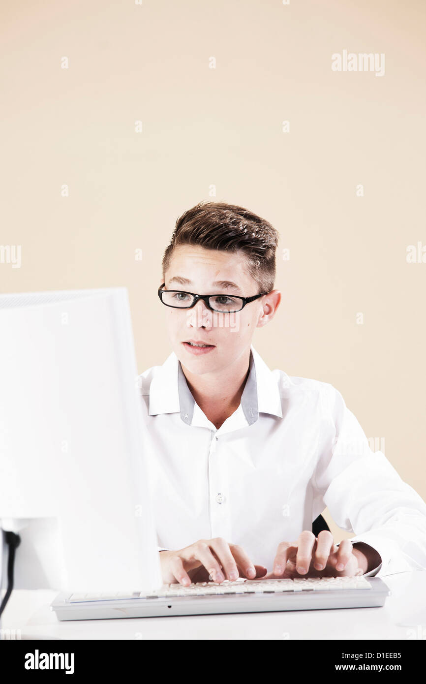 Teenage boy working at computer Stock Photo