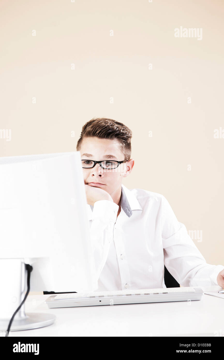 Teenage boy working at computer Stock Photo - Alamy