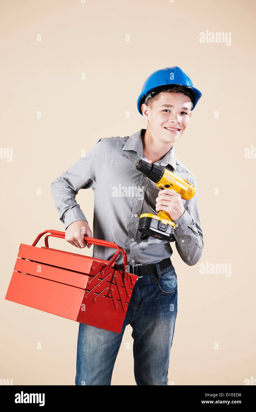 Teenage boy with hard helm and tool box Stock Photo
