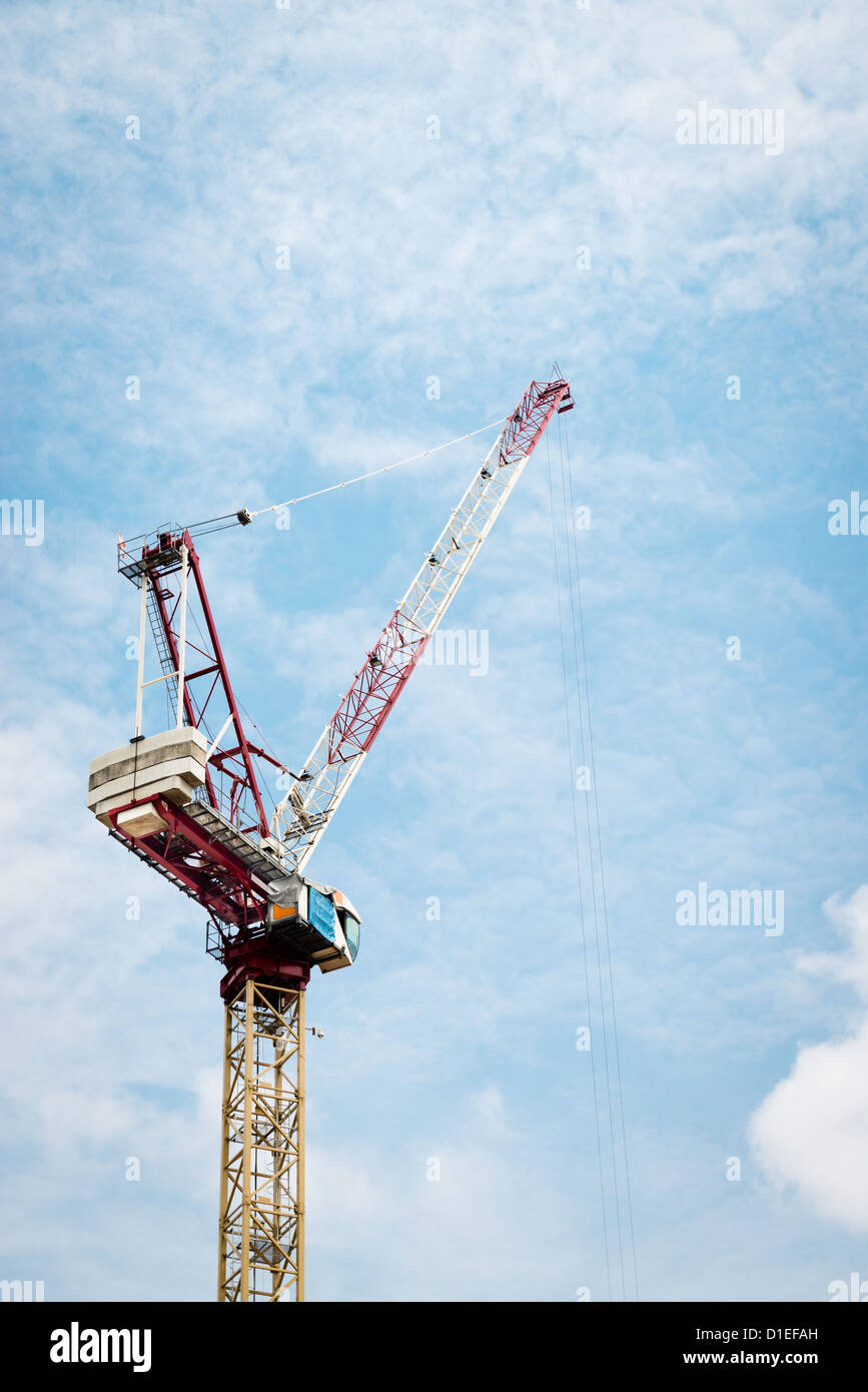Construction crane against cloudy blue sky in Singapore Stock Photo - Alamy