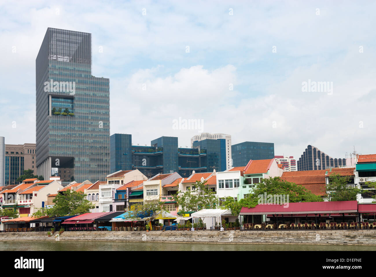 Boat quay in Singapore with seafood restaurants and skyscraper on