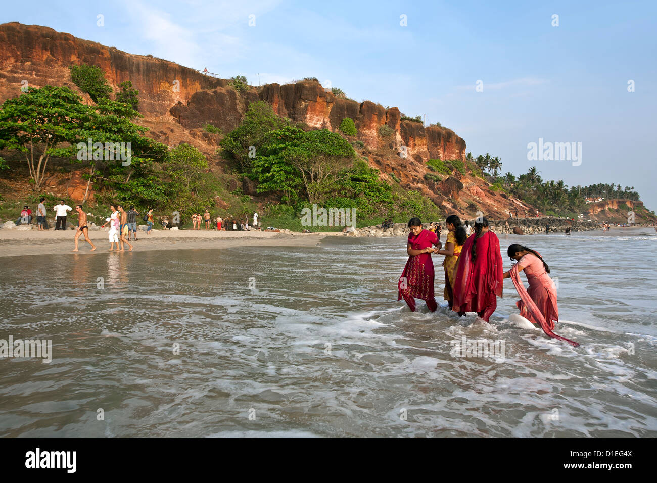 Young indian women bathing in the sea. Varkala beach. Kerala. India Stock Photo