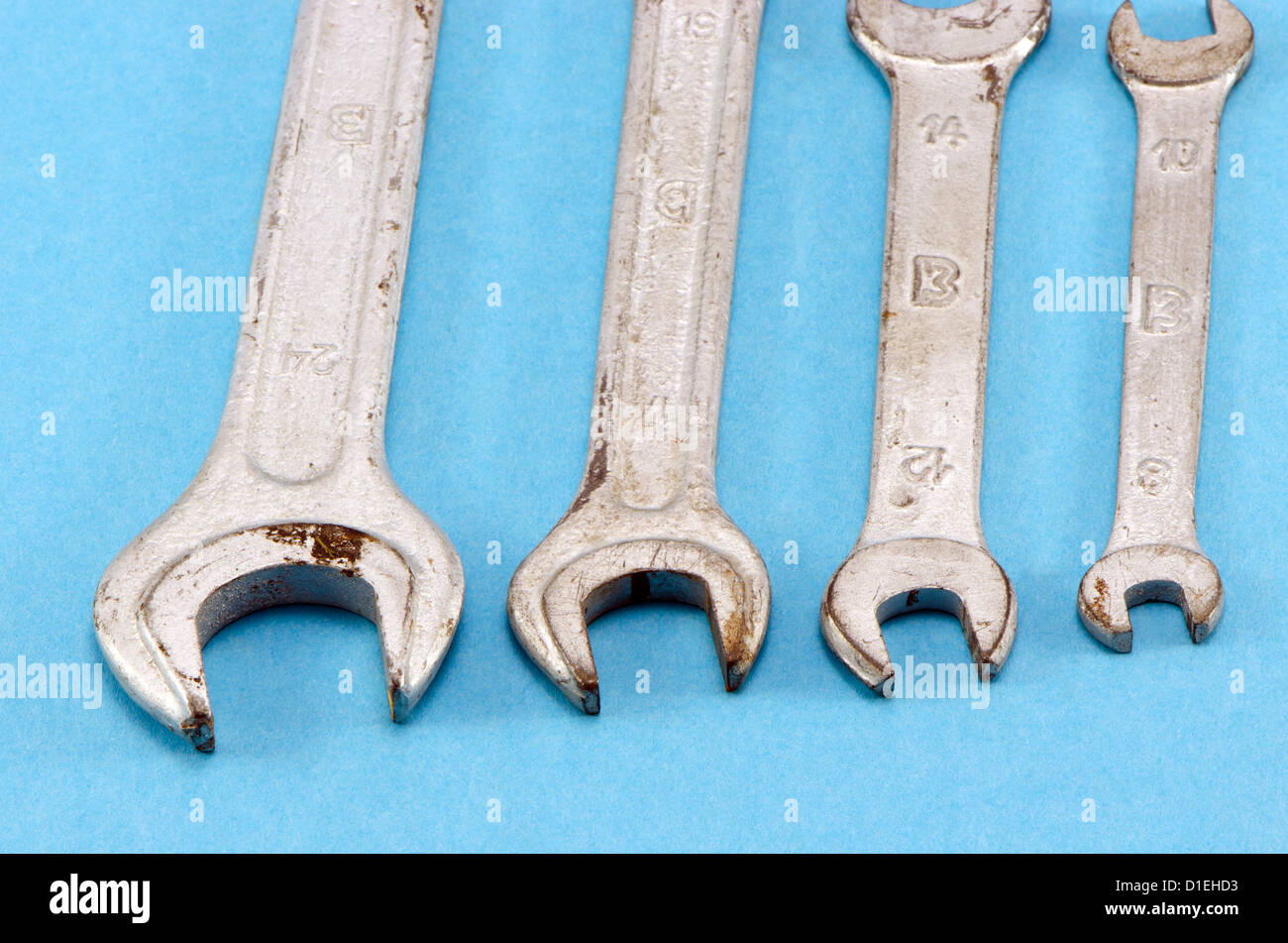 set different size combination wrench screw tools on blue background. Stock Photo
