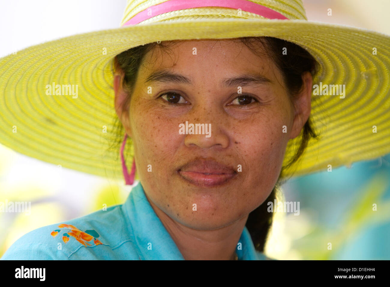 Portrait of a Thai woman wearing a hat at Chaweng beach on the island of Ko Samui, Thailand. Stock Photo