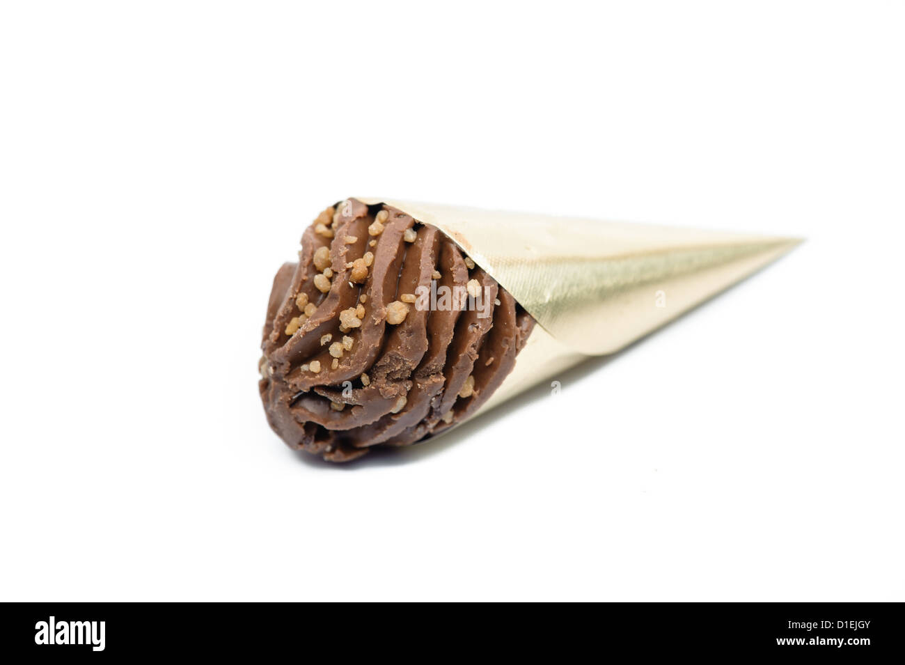 Handmade chocolate in gold foil cone against white background. Cutout Stock Photo
