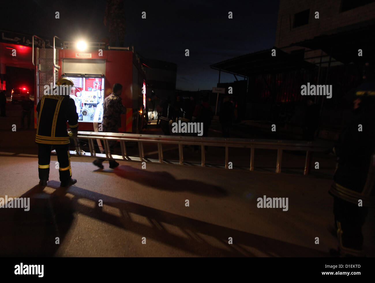 Dec. 18, 2012 - Ramallah, West Bank, Palestinian Territory - Palestinian firemen try to extinguish a fire after a fire broke out in a fuel tank at a filling station in Qalandia refugee camp near the West Bank city of Ramallah on 18 December 2012  (Credit Image: © Issam Rimawi/APA Images/ZUMAPRESS.com) Stock Photo