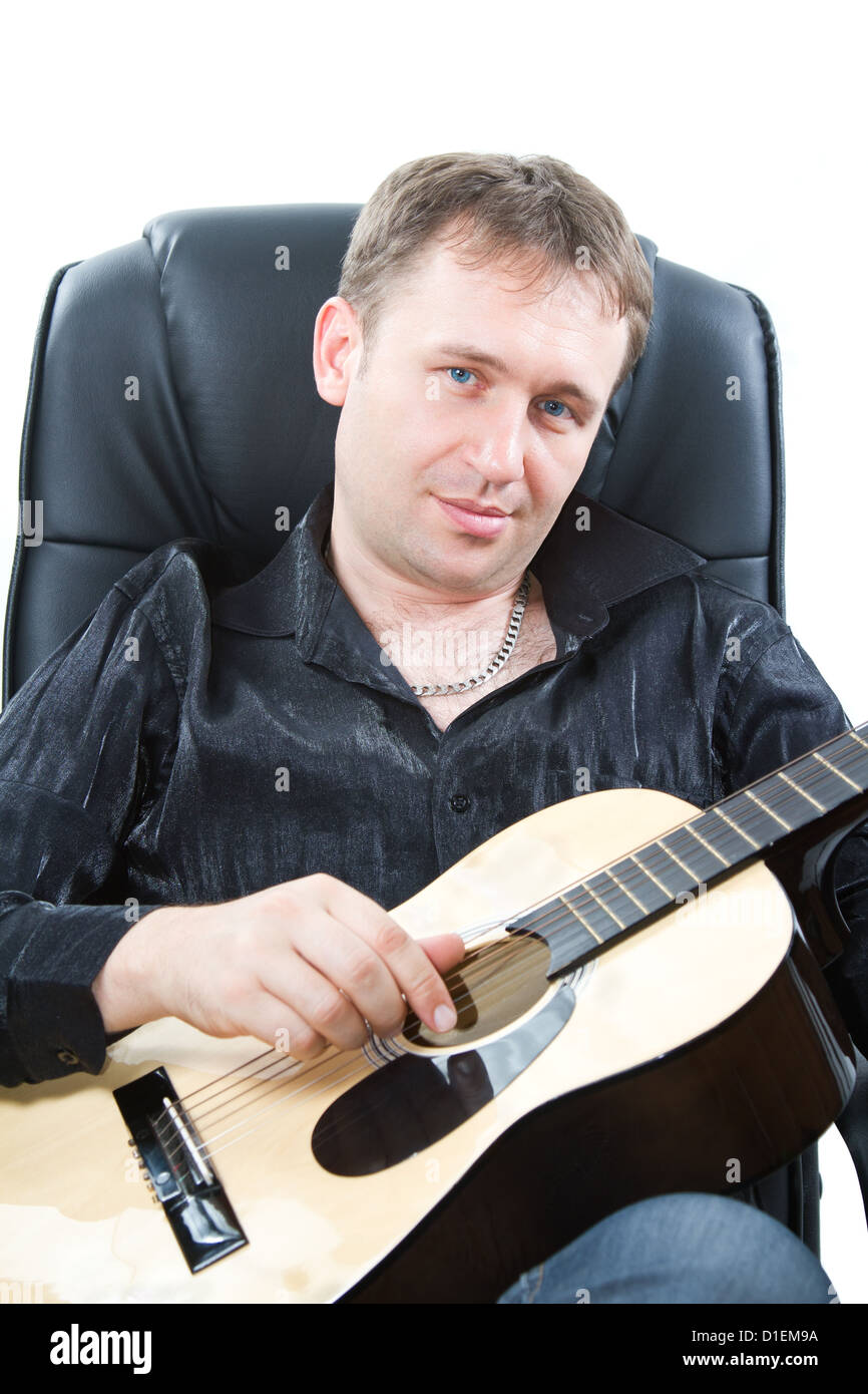 Musical instrument. Guitarist playing acoustic sixstring guitar