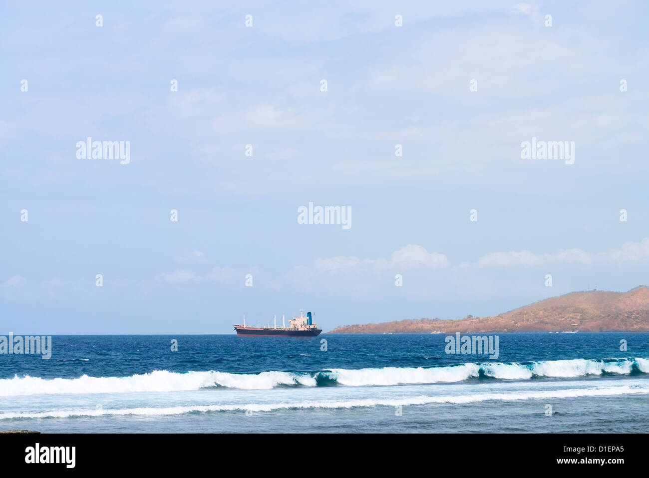 Blue sea and oil tanker, with cloudy sky and shore on background Stock ...