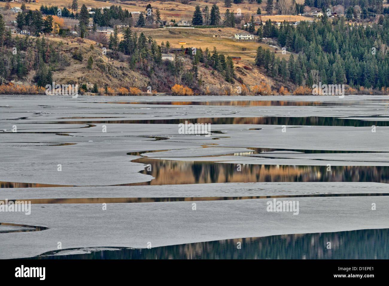 Reflections in Wood Lake, with melting ice at spring breakup, Vernon