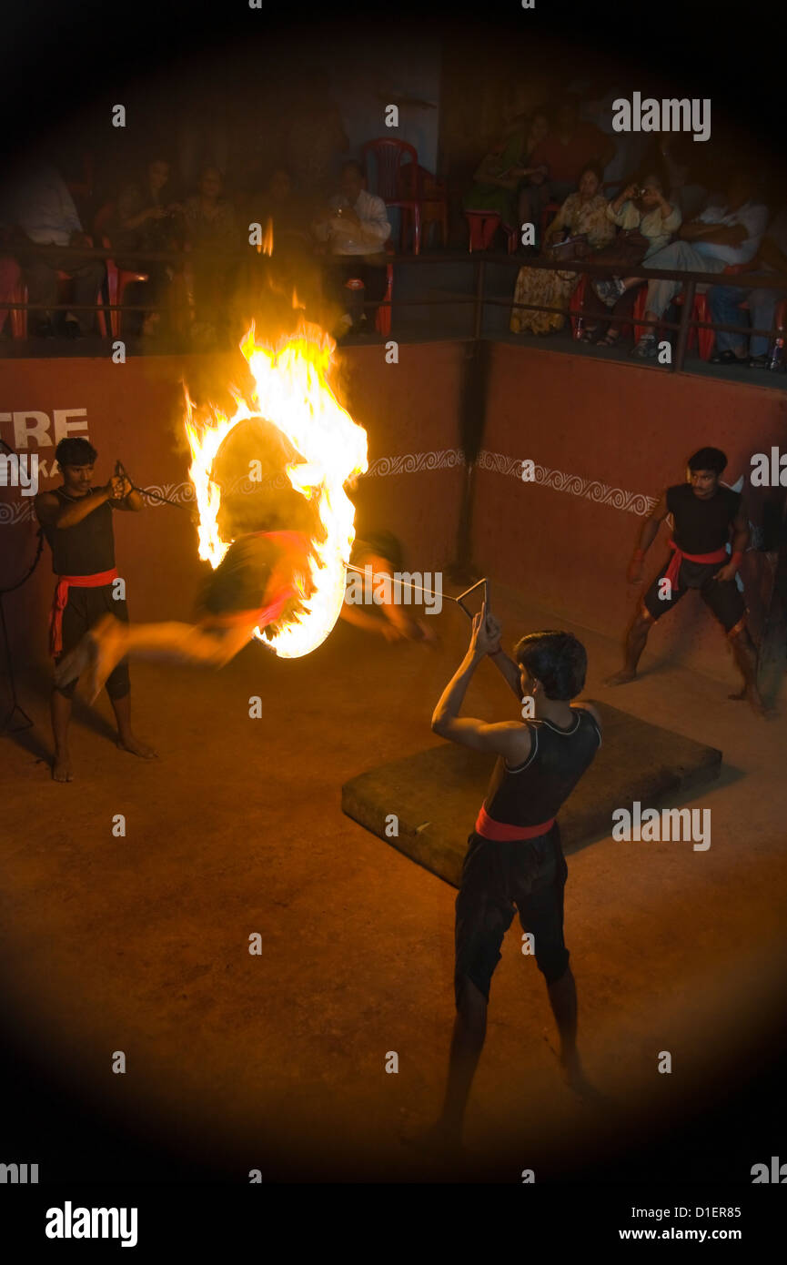 Vertical portrait of Kalaripayattu martial artists performing acrobatics in Kerala. Stock Photo