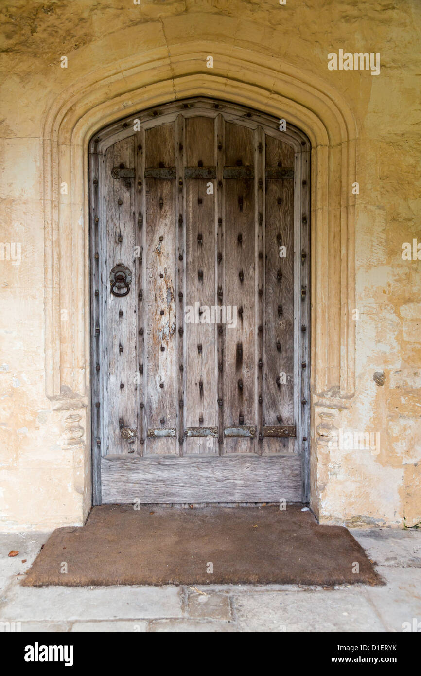 Old oak wood and stud door in cotswold stone entrance archway Stock Photo -  Alamy