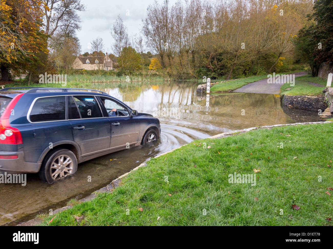 Car crossing through a deep river at road ford on Shill Brook at Shilton Oxfordshire Stock Photo