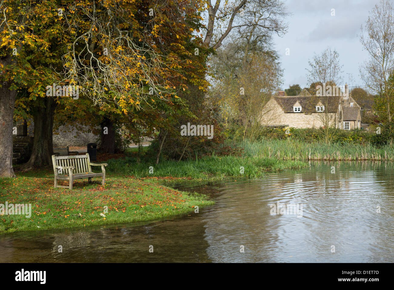 Seat overlooking a deep river at road ford on Shill Brook at Shilton Oxfordshire Stock Photo