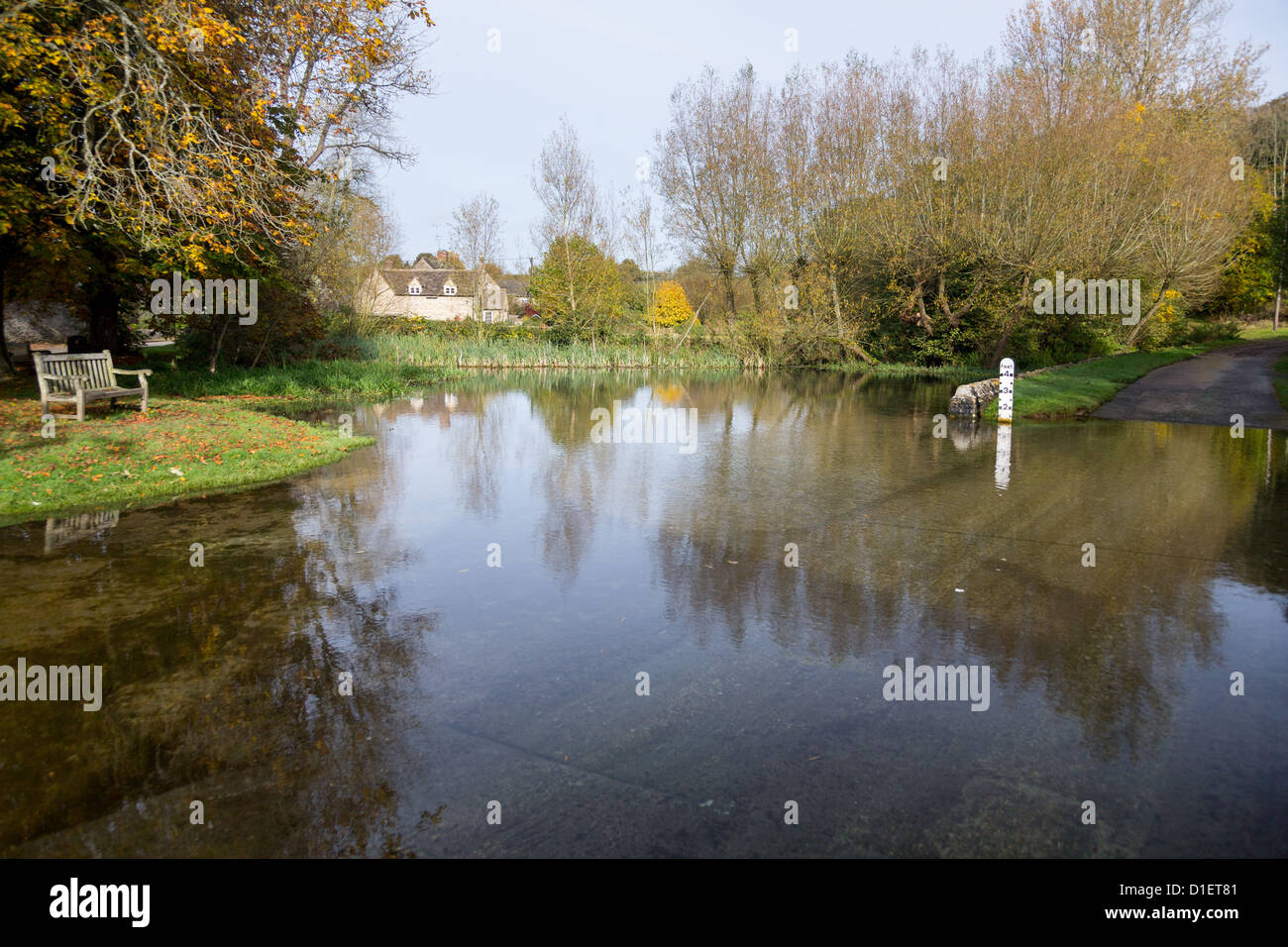 Seat overlooking a deep river at road ford on Shill Brook at Shilton Oxfordshire Stock Photo