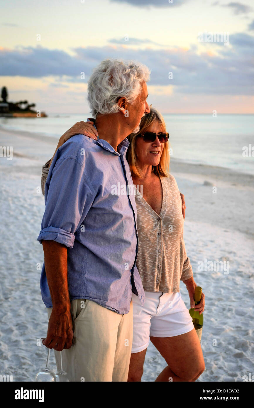Retired couple enjoy a romantic walk on Siesta Key beach Florida at