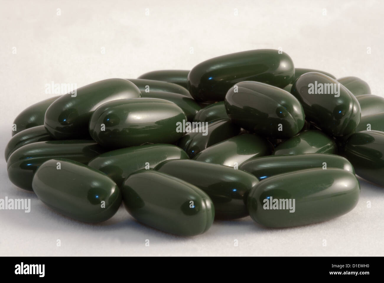 Dark green medical pills on white background Stock Photo Alamy