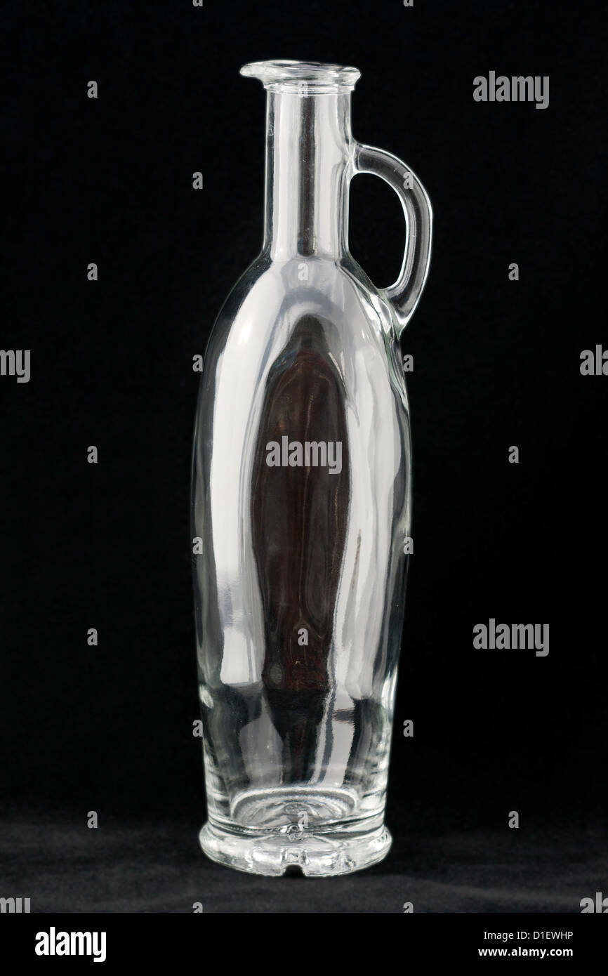Empty olive oil bottle against black background Stock Photo - Alamy