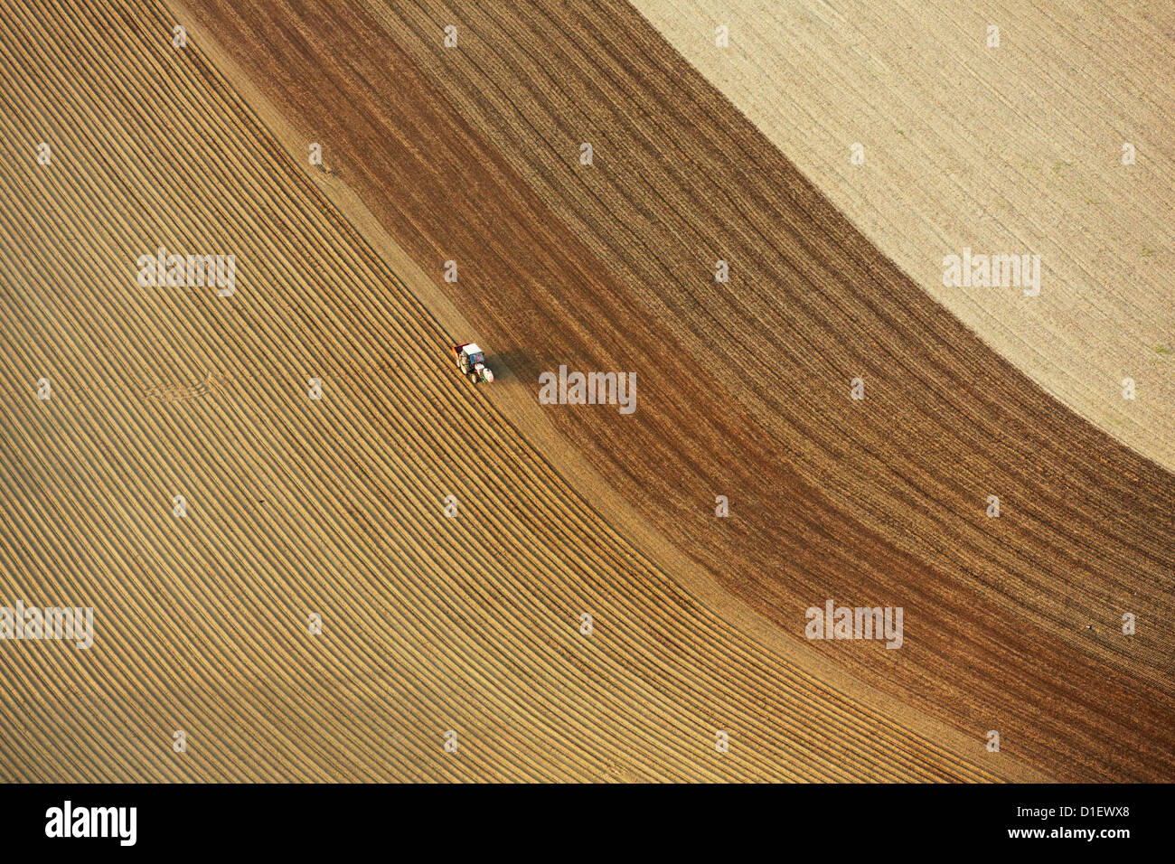 Tractor on plowed field, aerial photo Stock Photo - Alamy