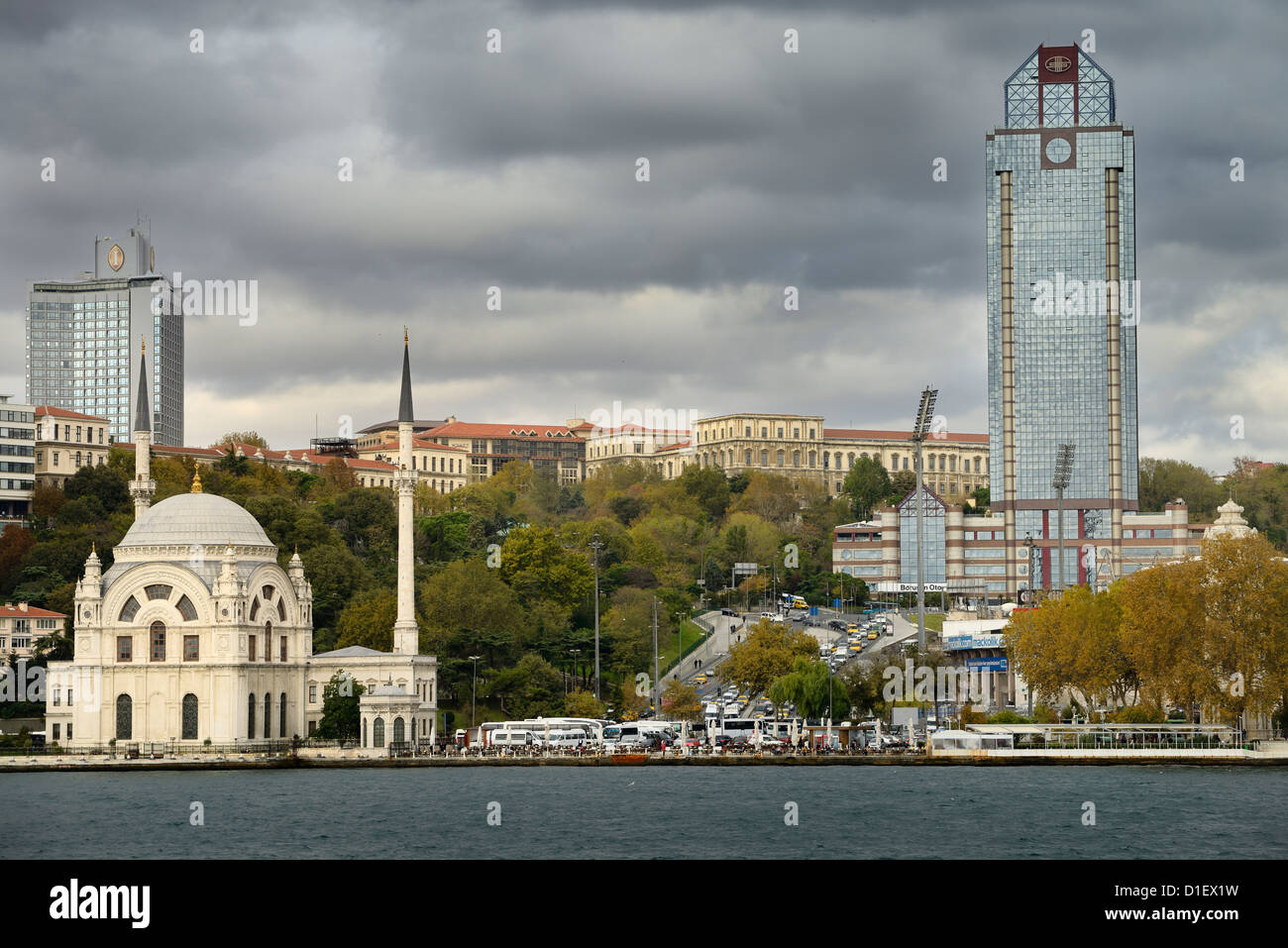 Dolmabahce Mosque surrounded by modern buildings on the Bosphorus Strait Istanbul Turkey Stock Photo