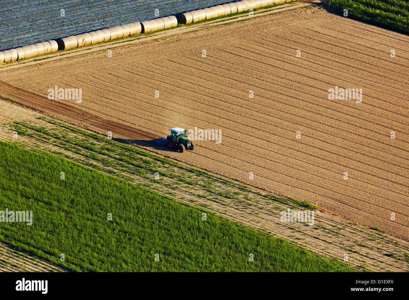 Tractor on plowed field, aerial photo Stock Photo - Alamy