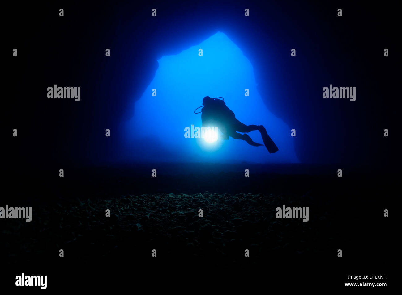 Diver in the entry of a cave, Mediterranean Sea near Gozo, Malta, underwater shot Stock Photo