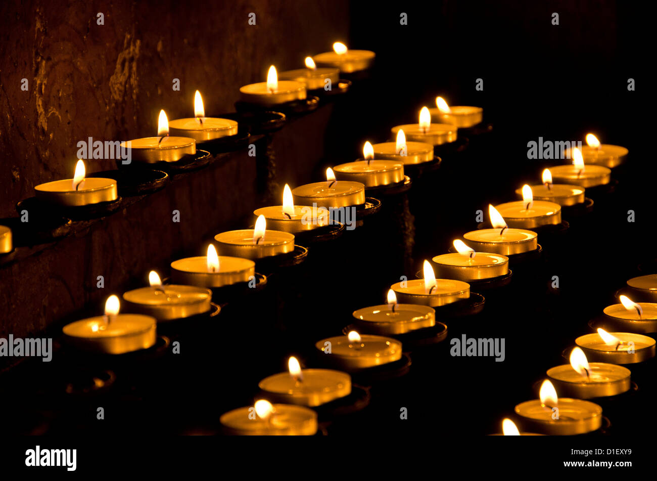 Burning candles in a church Stock Photo