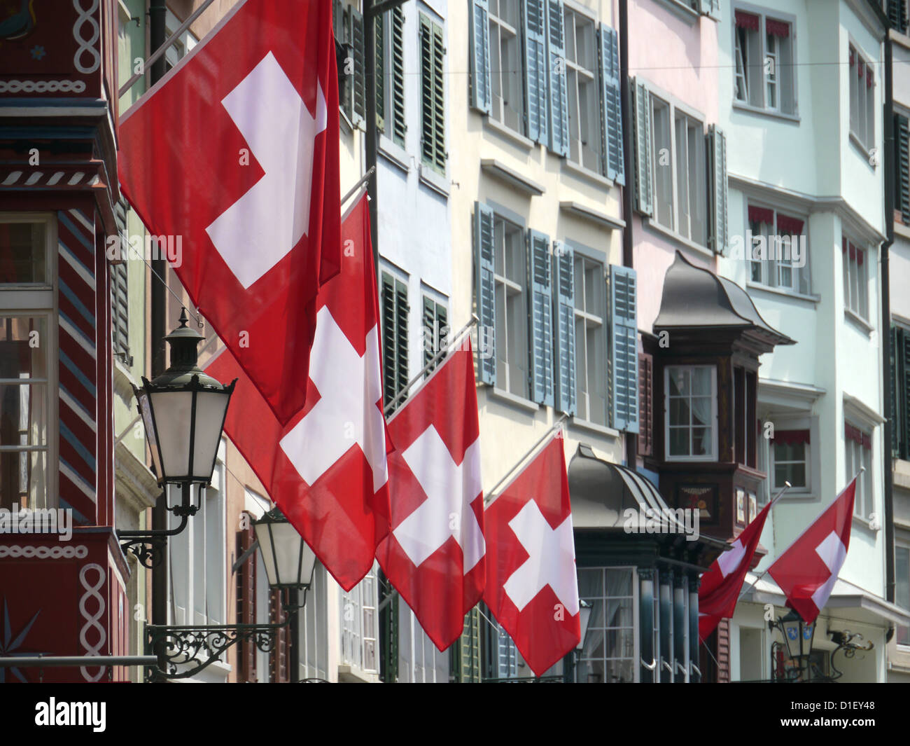 Swiss flags at house walls at national holiday, Zurich, Switzerland Stock Photo
