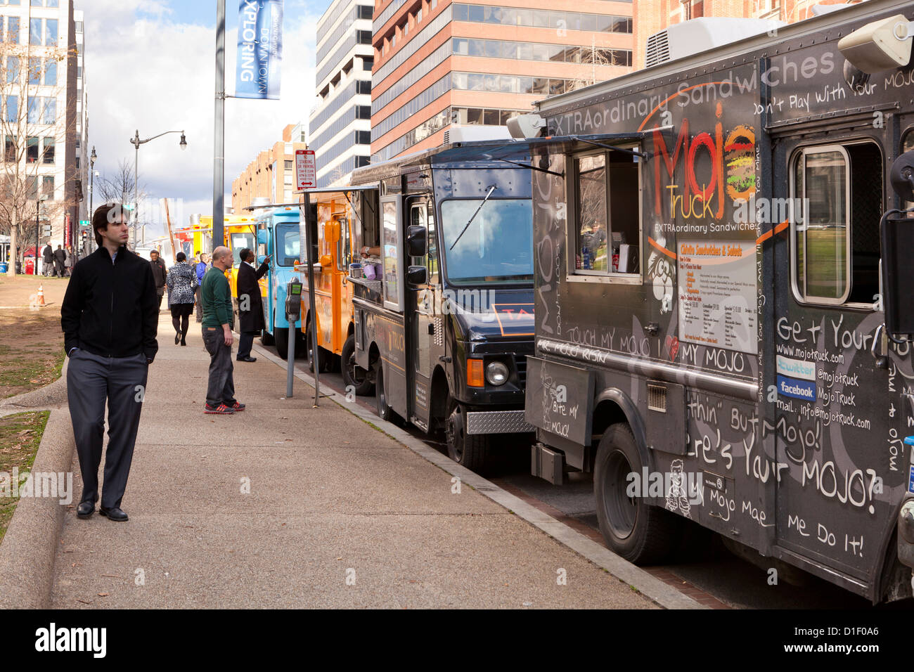Food trucks line up on an urban street - Washington, DC USA Stock Photo