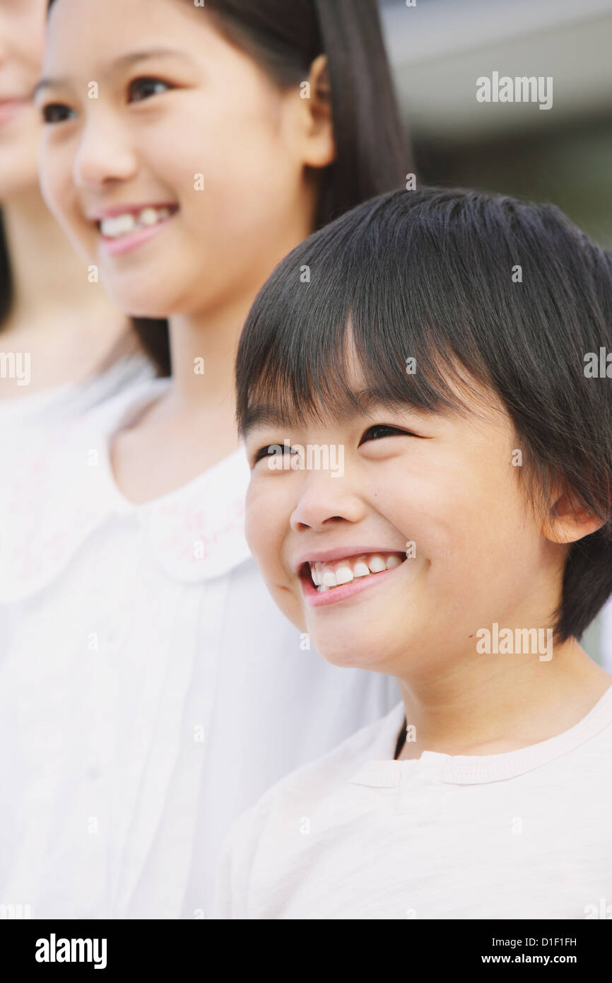 Close up of elementary age boy smiling and looking away Stock Photo - Alamy