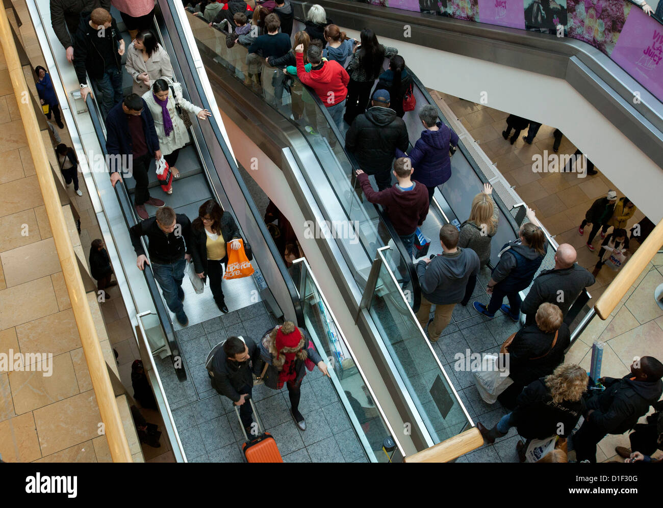 Escalators carrying shoppers inside the Bullring shopping centre Birmingham during the build up to Christmas. Stock Photo