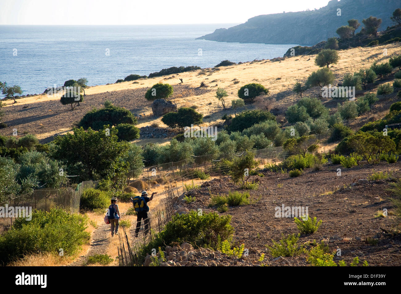 Couple hiking on coastal landscape, Crete, Greece Stock Photo