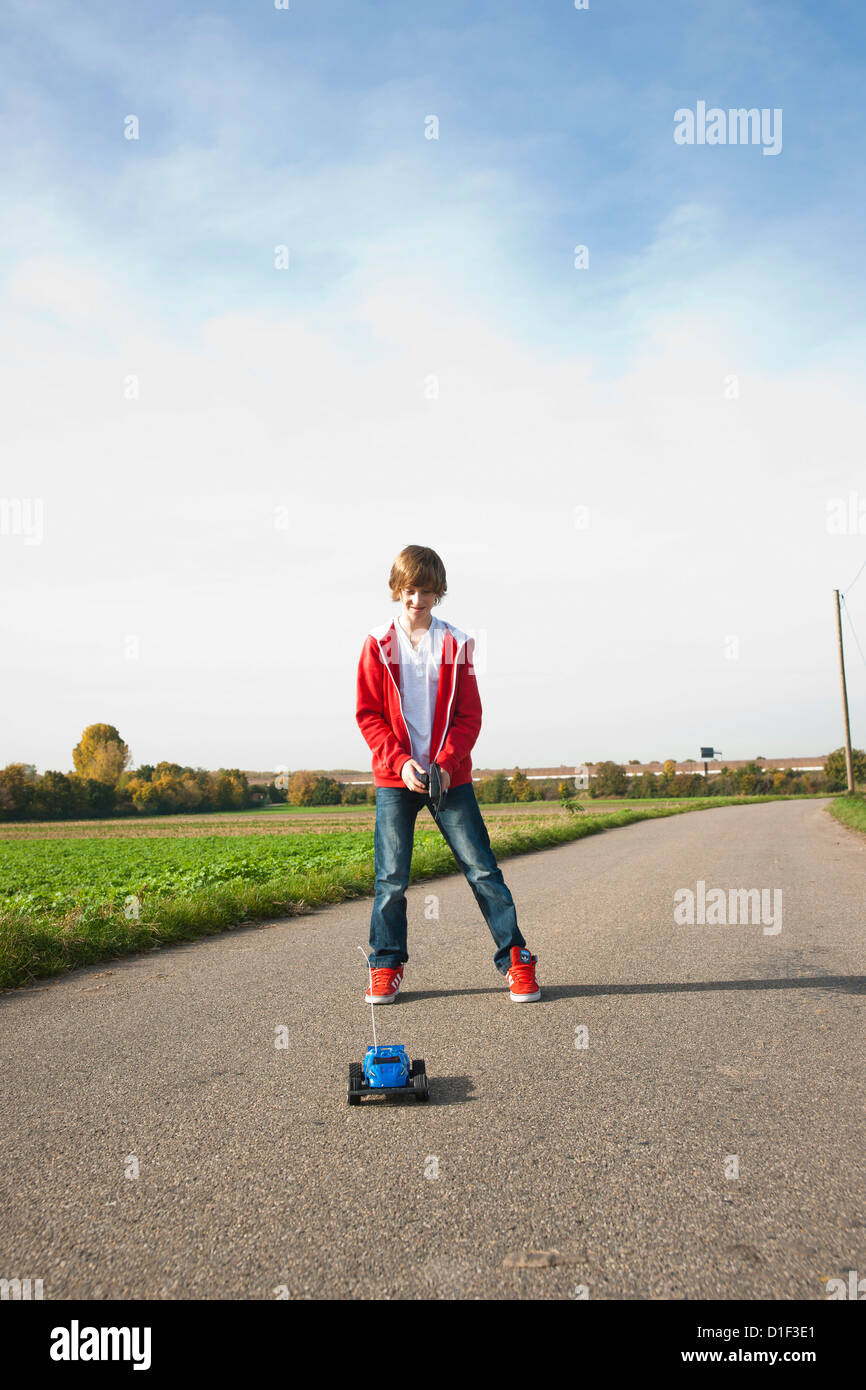 Boy playing with remote-controlled toy car Stock Photo