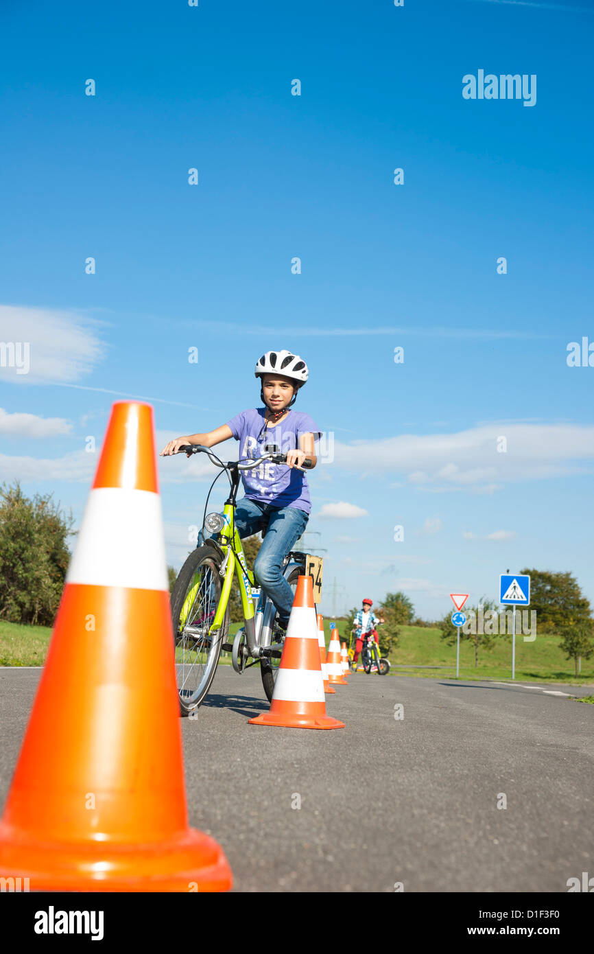 Girl practicing with bicycle on a closed course Stock Photo