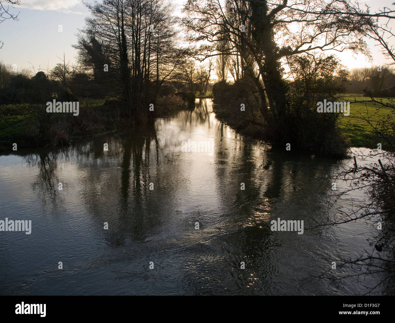 Winter landscape trees and water with low sun in sky River Deben, Ufford, Suffolk, England Stock Photo