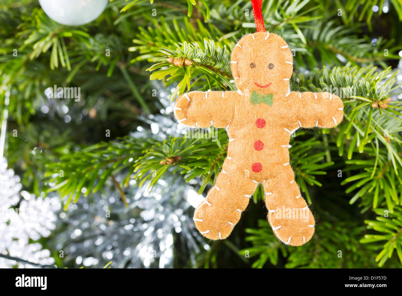Gingerbread man decoration on a christmas tree background Stock Photo
