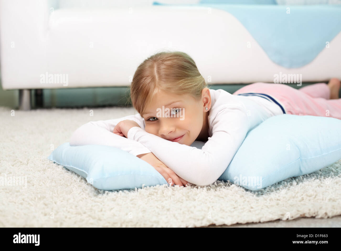 Portrait of lovely girl lying on the floor at home Stock Photo - Alamy